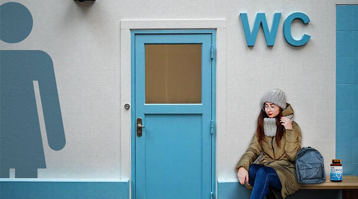 A woman is sitting in front of the toilet with Sheng-Pu Uricare Pill